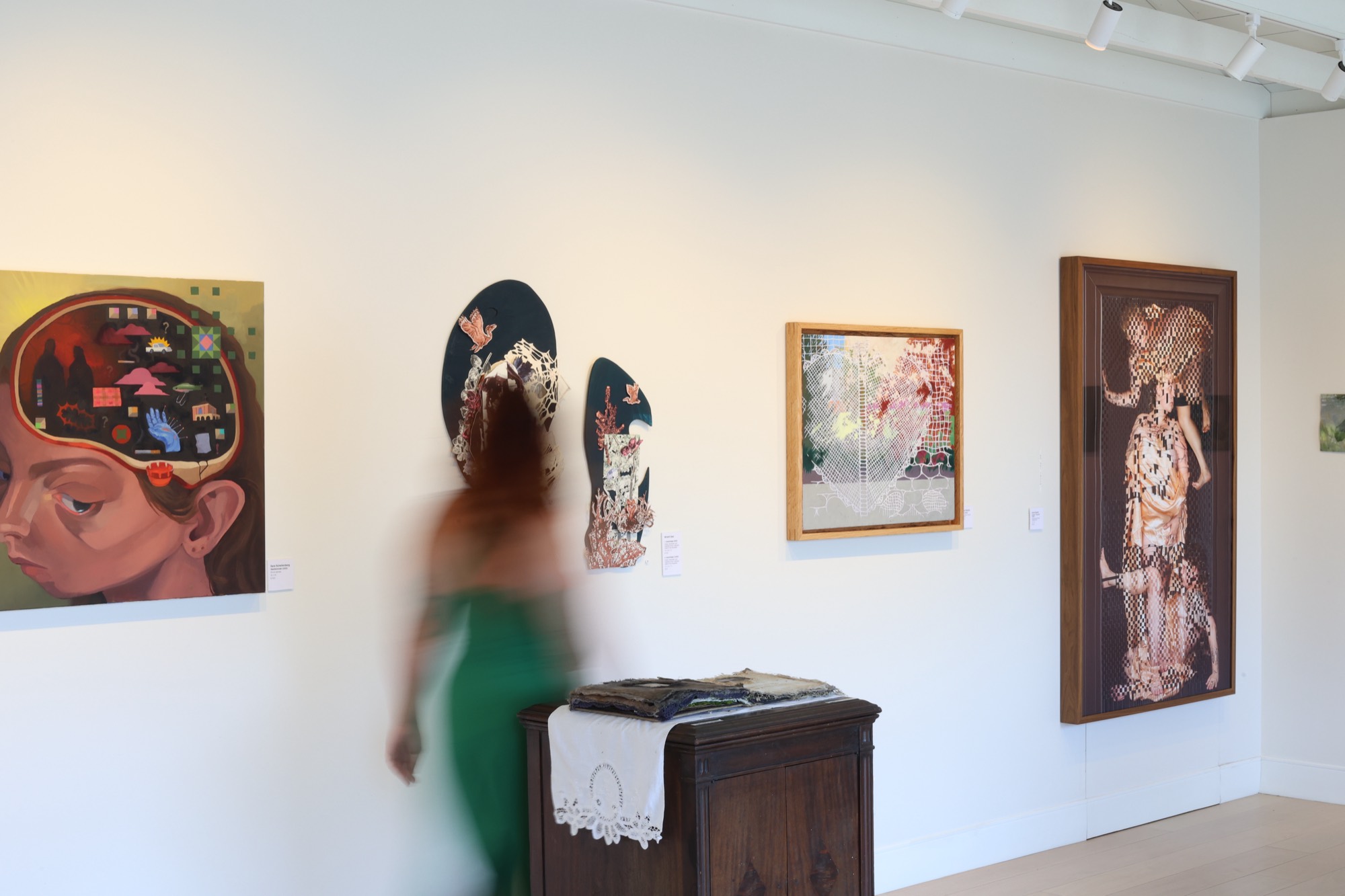 Inside The Midnight Gallery, white walls hung with local artists' work